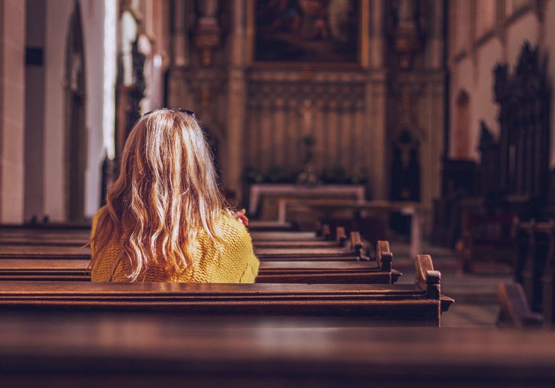 Young,Woman,Praying,And,Meditating,In,Church.,Belief,In,Jesus