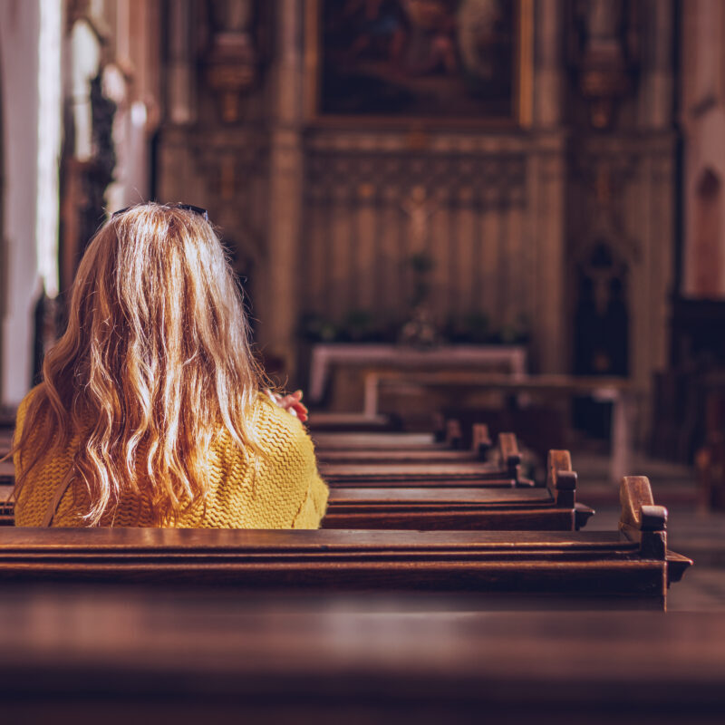 Young,Woman,Praying,And,Meditating,In,Church.,Belief,In,Jesus
